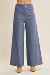 Blue wide-leg pants on a beige background