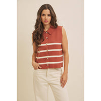 Woman wearing a sleeveless striped shirt with a beige background