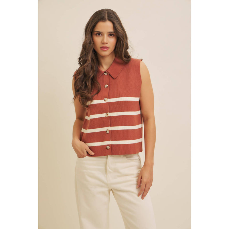 Woman wearing a sleeveless striped shirt with a beige background